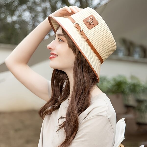 Stylish Newness Riviera Escape Straw Bucket Hat, perfect for summer adventures. Lightweight and versatile, in a natural straw color.