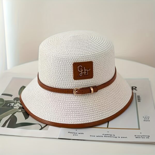 Stylish Newness Riviera Escape Straw Bucket Hat, perfect for summer adventures. Lightweight and versatile, in a natural straw color.