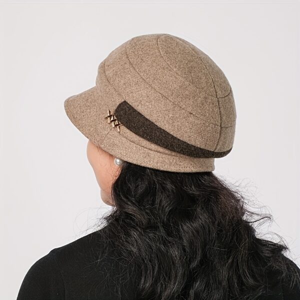 Stylish woman wearing a chic Newness Parisian Acrylic Beret Hat, perfect for winter. The hat is warm, comfortable, and effortlessly stylish.