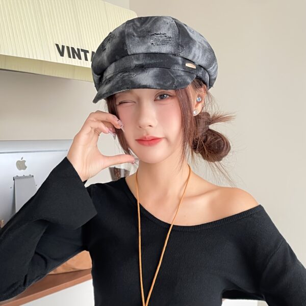 Newness Parisian Nights Distressed Suede Beret: A stylish, dark-toned suede beret with a distressed finish, adding Parisian chic to any outfit.