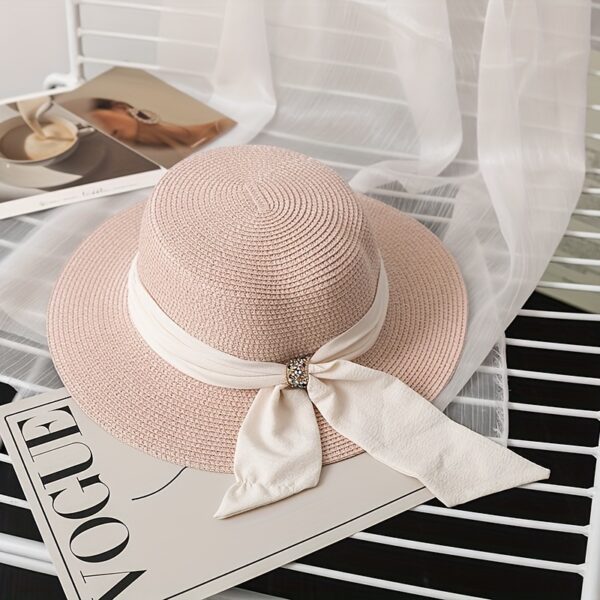 The Newness Riviera Bride Straw Hat: A stylish wide-brimmed straw hat, perfect for a beach wedding or destination bridal look. Offers elegant sun protection for the bride.