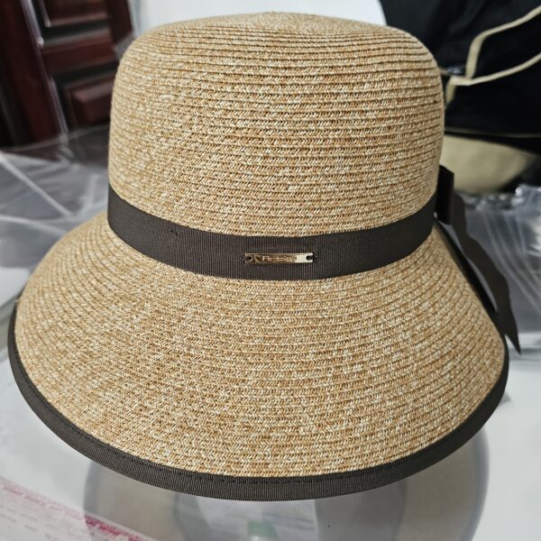 Stylish woman wearing a Newness Riviera Escape Women's Summer Fedora, a breathable and chic sun hat, perfect for a summer getaway.