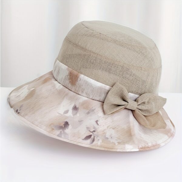Stylish woman wearing Newness Riviera Women's Sun Hat, enjoying a sunny day at the beach.