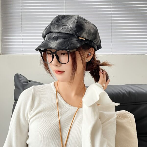 Newness Parisian Nights Distressed Suede Beret: A stylish, dark-toned suede beret with a distressed finish, adding Parisian chic to any outfit.