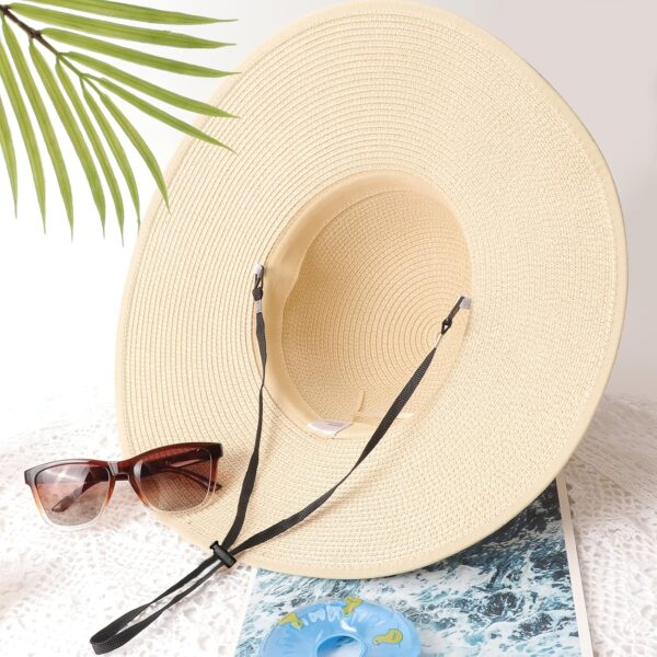 Stylish woman wearing a Newness St. Tropez Wide Brim Straw Hat, showcasing its foldable design and chic appearance.