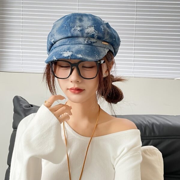 Newness Parisian Nights Distressed Suede Beret: A stylish, dark-toned suede beret with a distressed finish, adding Parisian chic to any outfit.