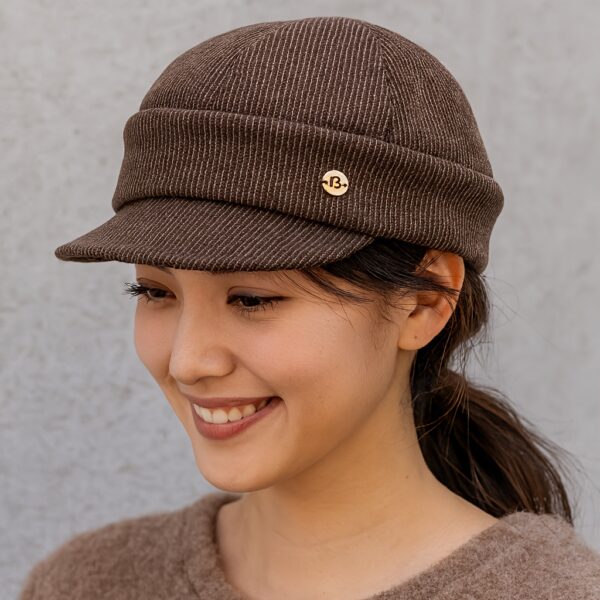 Stylish Newness Boulevard Newsboy Cap in winter setting. A close-up shows the texture and details of the warm, chic cap.