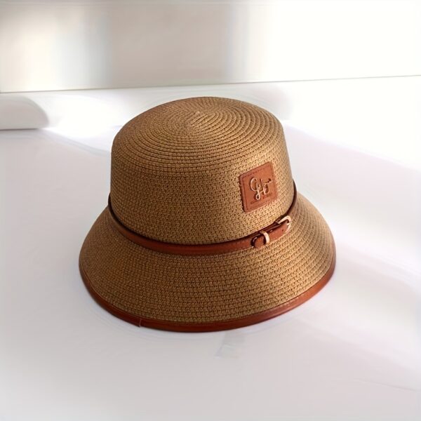 Stylish Newness Riviera Escape Straw Bucket Hat, perfect for summer adventures. Lightweight and versatile, in a natural straw color.