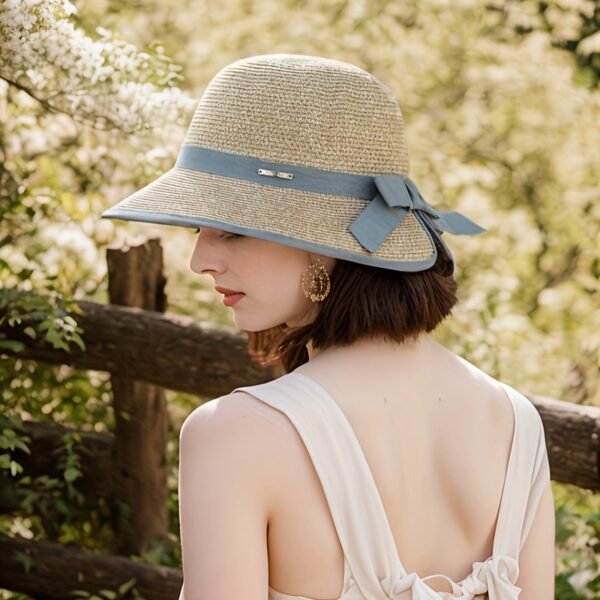 Stylish woman wearing a Newness Riviera Escape Women's Summer Fedora, a breathable and chic sun hat, perfect for a summer getaway.
