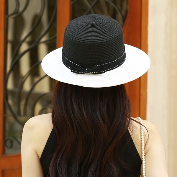 Stylish wide-brimmed straw sun hat, perfect for escaping to the Riviera or any sunny destination. Breathable and chic.