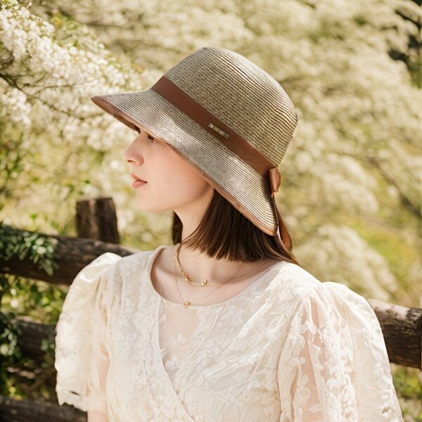 Stylish woman wearing a Newness Riviera Escape Women's Summer Fedora, a breathable and chic sun hat, perfect for a summer getaway.
