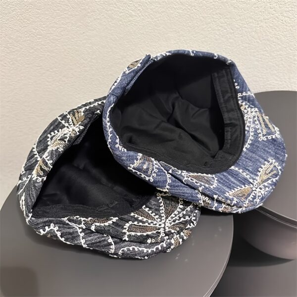 Newness Midnight Bloom Embroidered Beret in blue and black floral denim with golden accents. Lightweight, stylish, and perfect for streetwear.