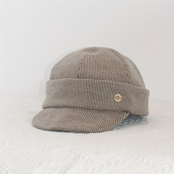 Stylish Newness Boulevard Newsboy Cap in winter setting. A close-up shows the texture and details of the warm, chic cap.