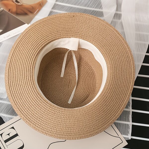 The Newness Riviera Bride Straw Hat: A stylish wide-brimmed straw hat, perfect for a beach wedding or destination bridal look. Offers elegant sun protection for the bride.