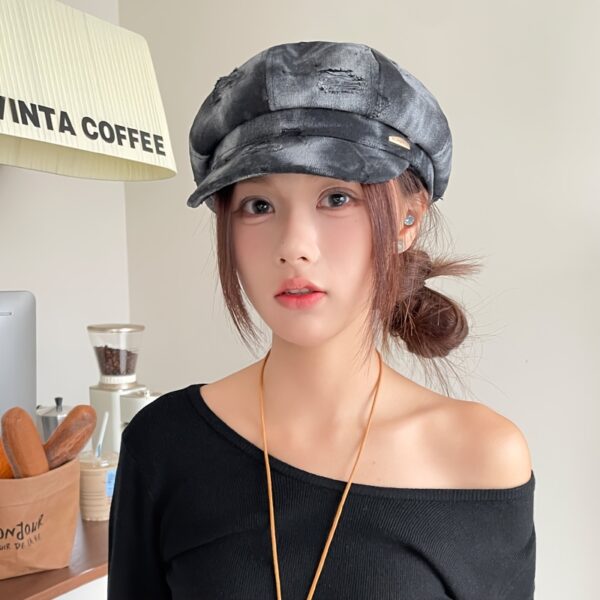 Newness Parisian Nights Distressed Suede Beret: A stylish, dark-toned suede beret with a distressed finish, adding Parisian chic to any outfit.