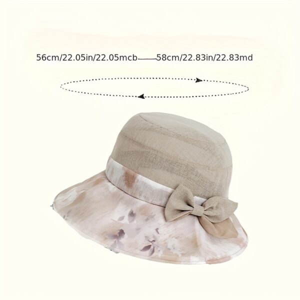 Stylish woman wearing Newness Riviera Women's Sun Hat, enjoying a sunny day at the beach.