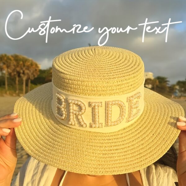 The Newness Riviera Bride Straw Hat: A stylish wide-brimmed straw hat, perfect for a beach wedding or destination bridal look. Offers elegant sun protection for the bride.