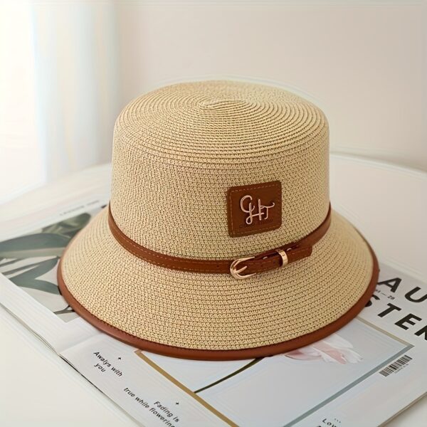 Stylish Newness Riviera Escape Straw Bucket Hat, perfect for summer adventures. Lightweight and versatile, in a natural straw color.