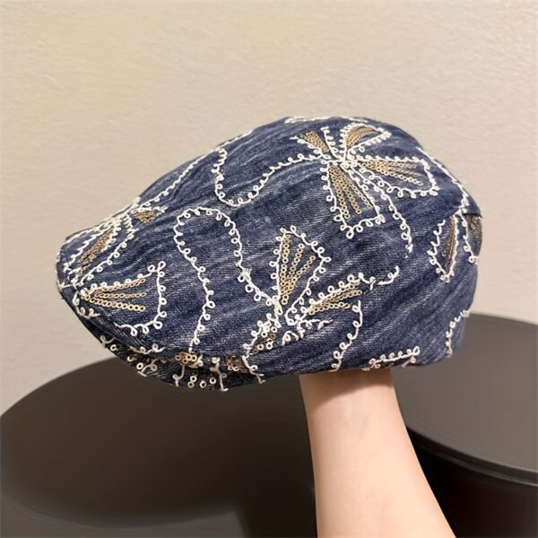 Newness Midnight Bloom Embroidered Beret in blue and black floral denim with golden accents. Lightweight, stylish, and perfect for streetwear.