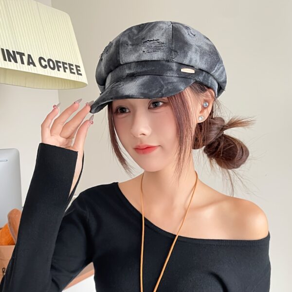 Newness Parisian Nights Distressed Suede Beret: A stylish, dark-toned suede beret with a distressed finish, adding Parisian chic to any outfit.