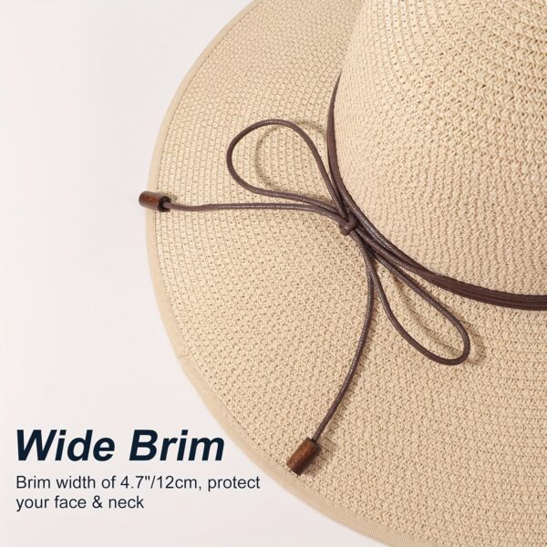 Stylish woman wearing a Newness St. Tropez Wide Brim Straw Hat, showcasing its foldable design and chic appearance.