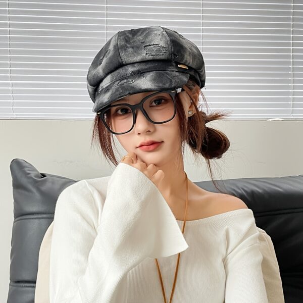 Newness Parisian Nights Distressed Suede Beret: A stylish, dark-toned suede beret with a distressed finish, adding Parisian chic to any outfit.