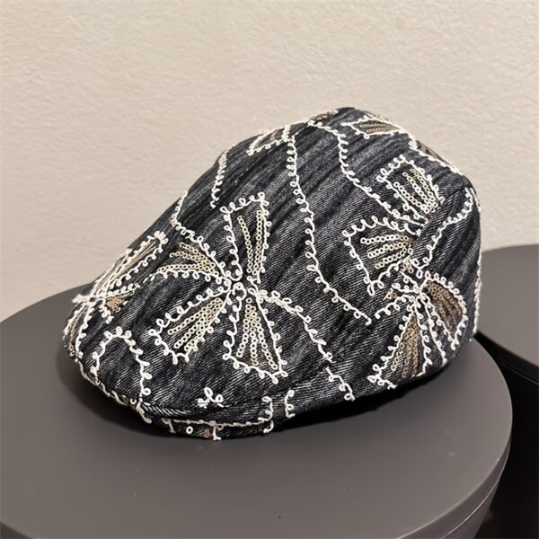 Newness Midnight Bloom Embroidered Beret in blue and black floral denim with golden accents. Lightweight, stylish, and perfect for streetwear.