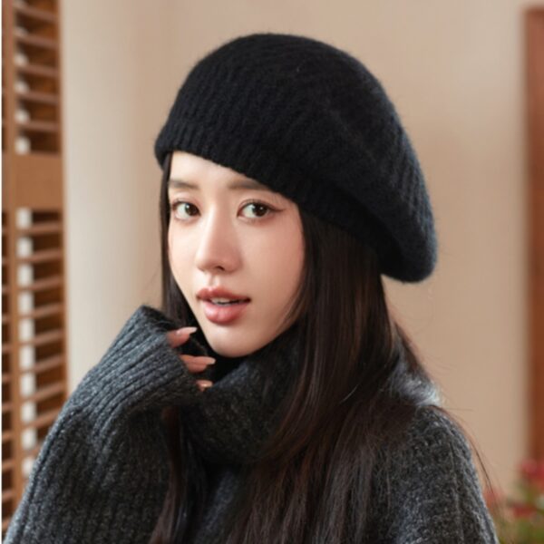 Flattering close-up of a woman wearing the Newness Parisian Women's Beret Hat, showcasing its stylish design and perfect fit. The hat is a rich, deep color that complements her complexion.