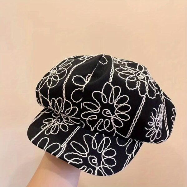 Midnight Bloom Embroidered Beret Cap by Newness. A stylish black beret with delicate embroidery, perfect for adding a touch of Parisian chic to any outfit.