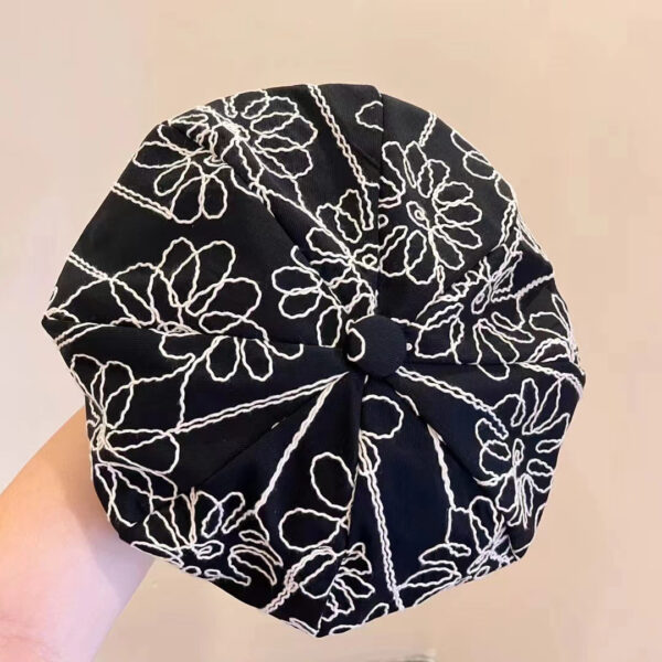 Midnight Bloom Embroidered Beret Cap by Newness. A stylish black beret with delicate embroidery, perfect for adding a touch of Parisian chic to any outfit.