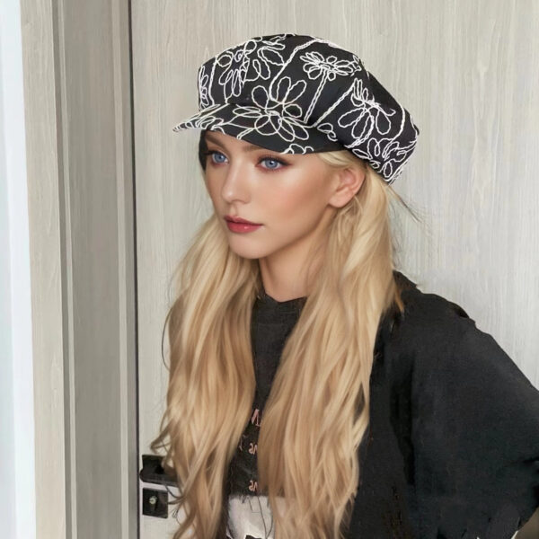 Midnight Bloom Embroidered Beret Cap by Newness. A stylish black beret with delicate embroidery, perfect for adding a touch of Parisian chic to any outfit.