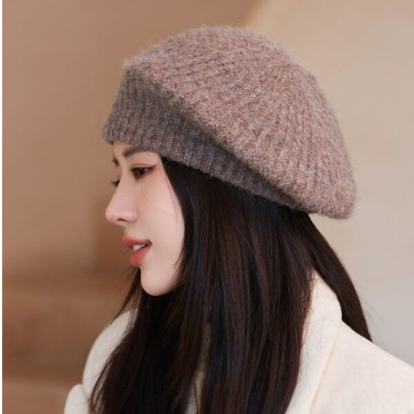 Flattering close-up of a woman wearing the Newness Parisian Women's Beret Hat, showcasing its stylish design and perfect fit. The hat is a rich, deep color that complements her complexion.
