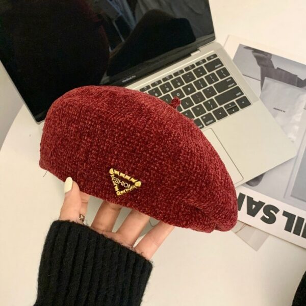 The Parisian Winter Beret Hat by Newness in a rich burgundy color, styled effortlessly with a classic autumn outfit.