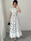 Model wearing a chic butterfly print dress perfect for summer The dress is made of lightweight polyester and floats beautifully
