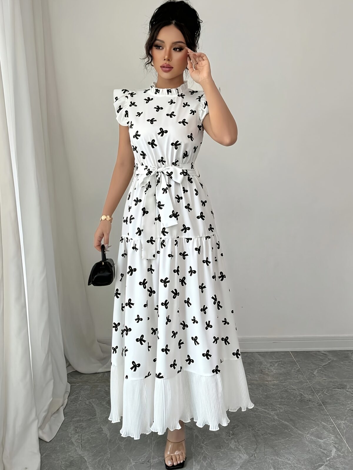 Model wearing a chic butterfly print dress perfect for summer The dress is made of lightweight polyester and floats beautifully