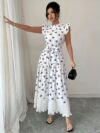 Model wearing a chic butterfly print dress perfect for summer The dress is made of lightweight polyester and floats beautifully