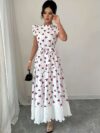 Model wearing a chic butterfly print dress perfect for summer The dress is made of lightweight polyester and floats beautifully