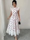 Model wearing a chic butterfly print dress perfect for summer The dress is made of lightweight polyester and floats beautifully