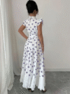 Model wearing a chic butterfly print dress perfect for summer The dress is made of lightweight polyester and floats beautifully
