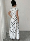Model wearing a chic butterfly print dress perfect for summer The dress is made of lightweight polyester and floats beautifully