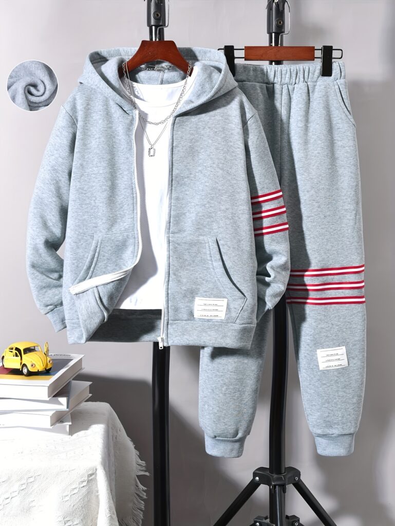 Stylish boys' two-tone striped sweatshirt and jogger set, perfect for casual wear. The comfortable outfit features a trendy design ideal for boys aged 12 and under.