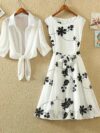 Model wearing the Newness Summer Solstice Floral Print Dress a chic and flattering midi dress with a retro inspired floral print perfect for summer