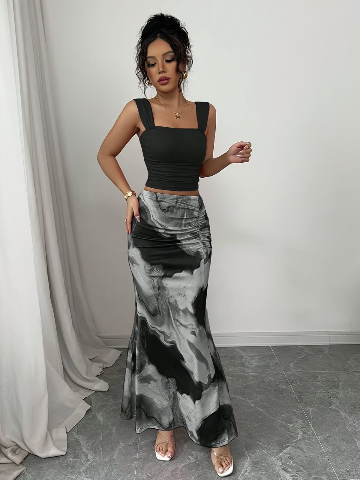 Model wearing the Newness Sunset Hues Ombre Skirt Set a chic two piece outfit featuring a gradient ombre effect in sunset colors The set includes a matching top and skirt showcasing a sophisticated and effortlessly cool summer style