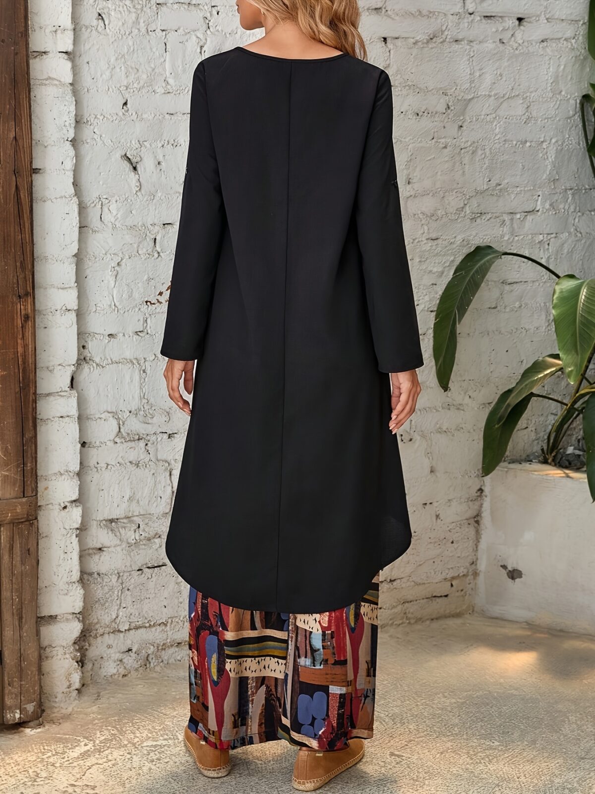 Model showcasing the Newness Casablanca Abstract Print Set a stylish two piece outfit with a solid color top and vibrant abstract print pants