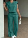 Model wearing the Newness Effortless Chic Sleeveless Wide Leg Set a stylish and comfortable two piece outfit featuring a sleeveless top and wide leg pants in luxurious polyester