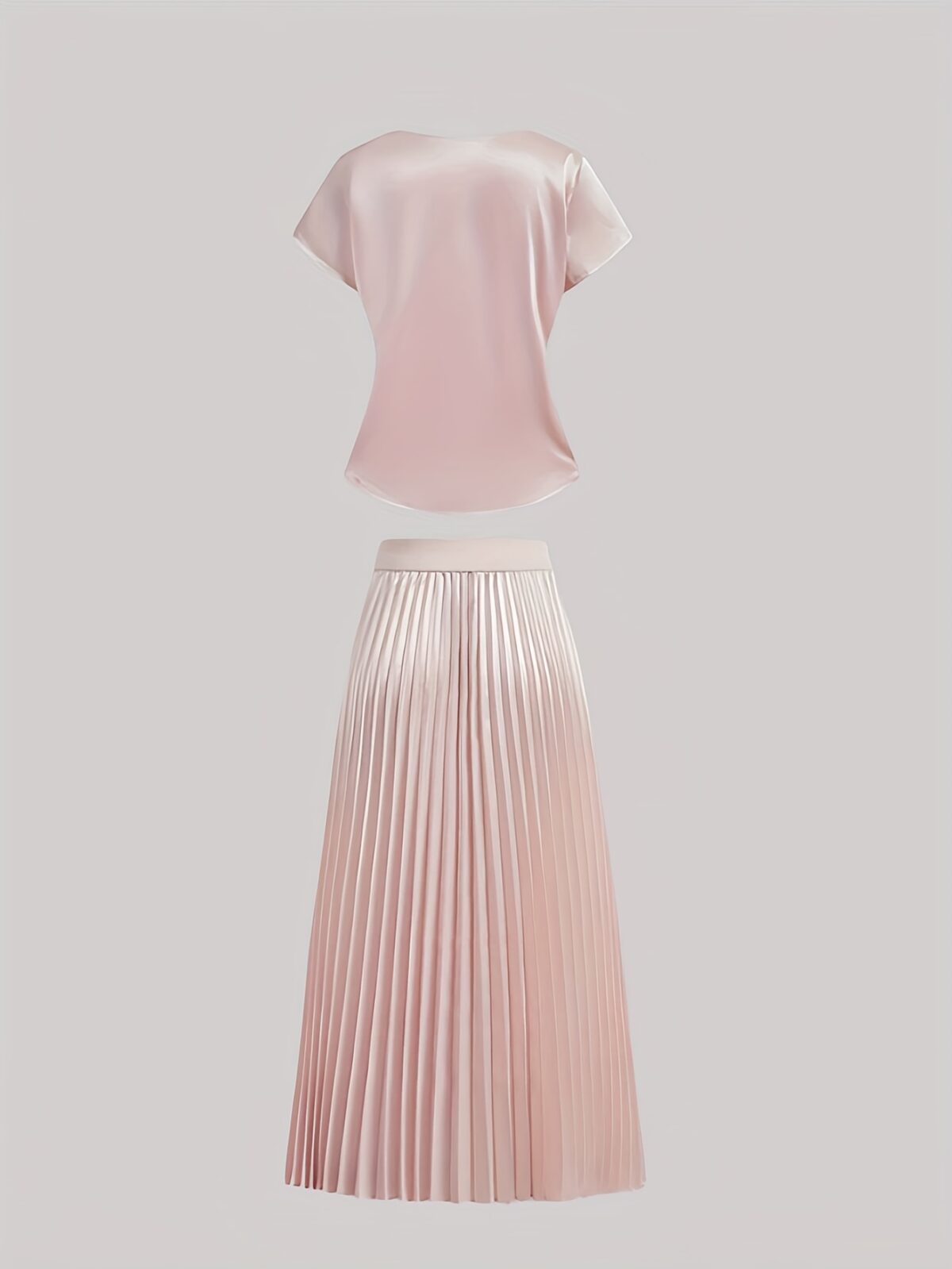 Flatlay of the Newness Bisous Rosé pink pleated midi set showcasing the skirt and top separately and together The set is a beautiful shade of pink and features delicate pleats