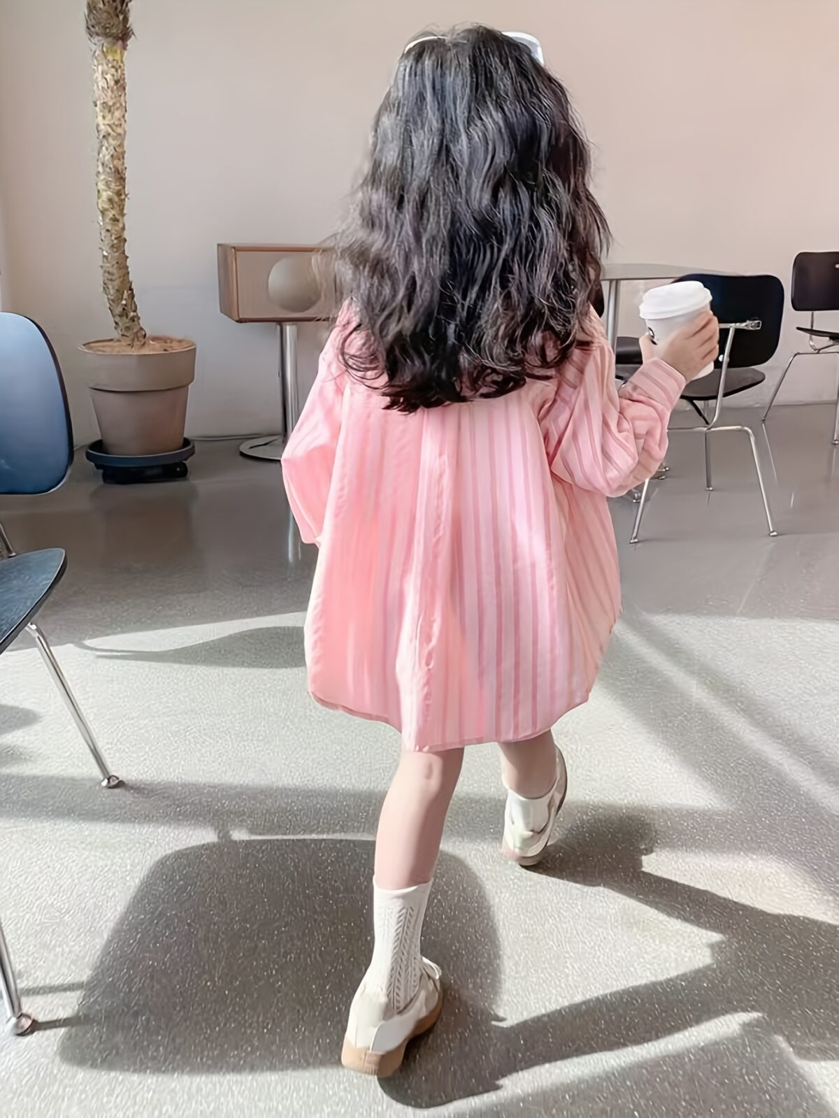 Adorable girl wearing Newness Riviera Chic summer outfit a stylish and breathable dress perfect for sunny days