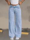 Model wearing Newness Dubai Breeze Wide Leg Jeans a light wash high waisted pair of wide leg jeans