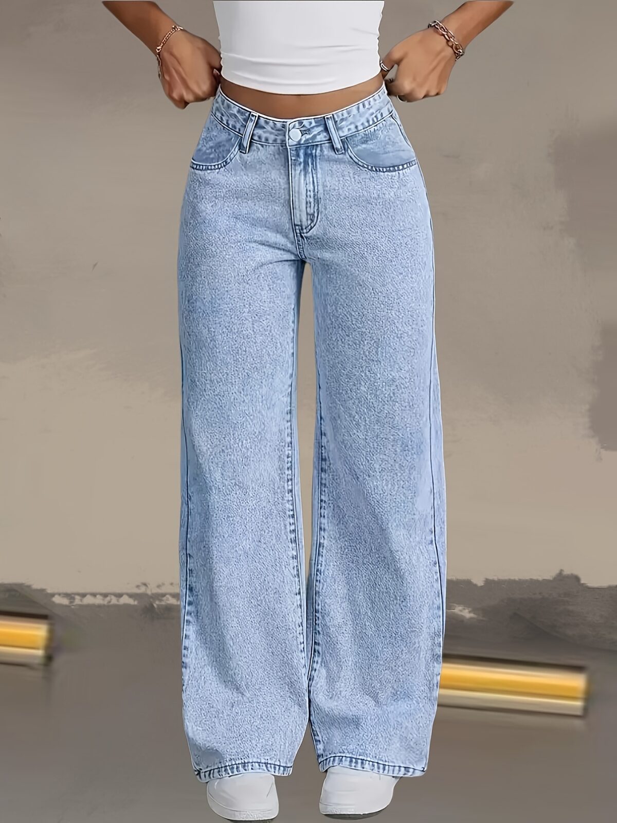 Model wearing Newness Dubai Breeze Wide Leg Jeans a light wash high waisted pair of wide leg jeans