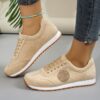 Womens classic flannel low top lace up sneakers with rubber sole shown from the side in a neutral color